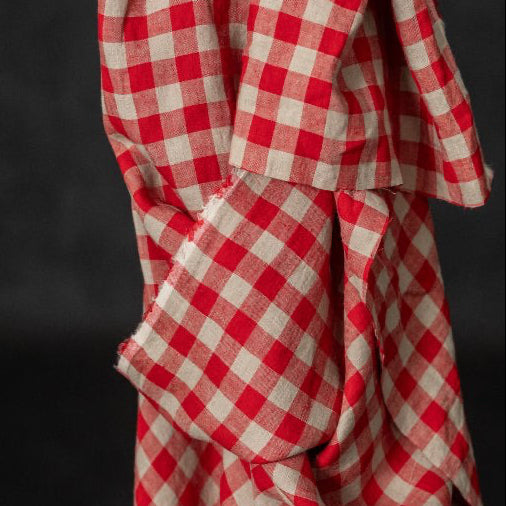 Red and  Flax checkered fabric draped over a black background