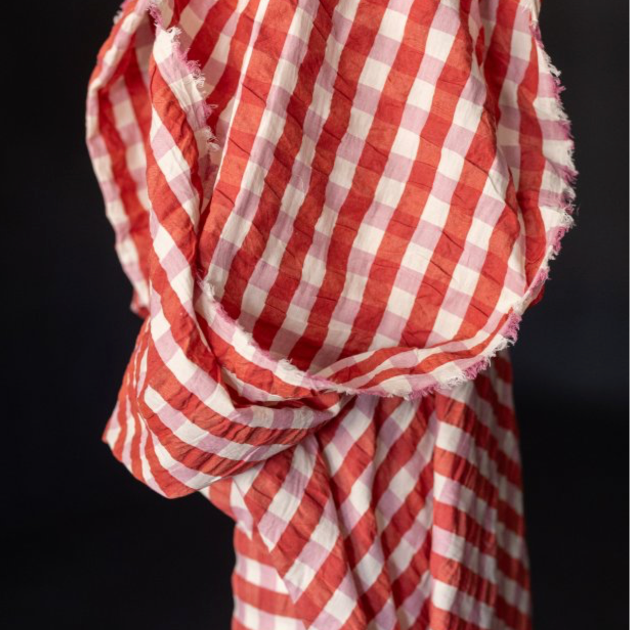 Red and white checkered fabric on a black background