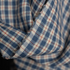 Close-up of a plaid fabric with a blue, white, and red checkered pattern.