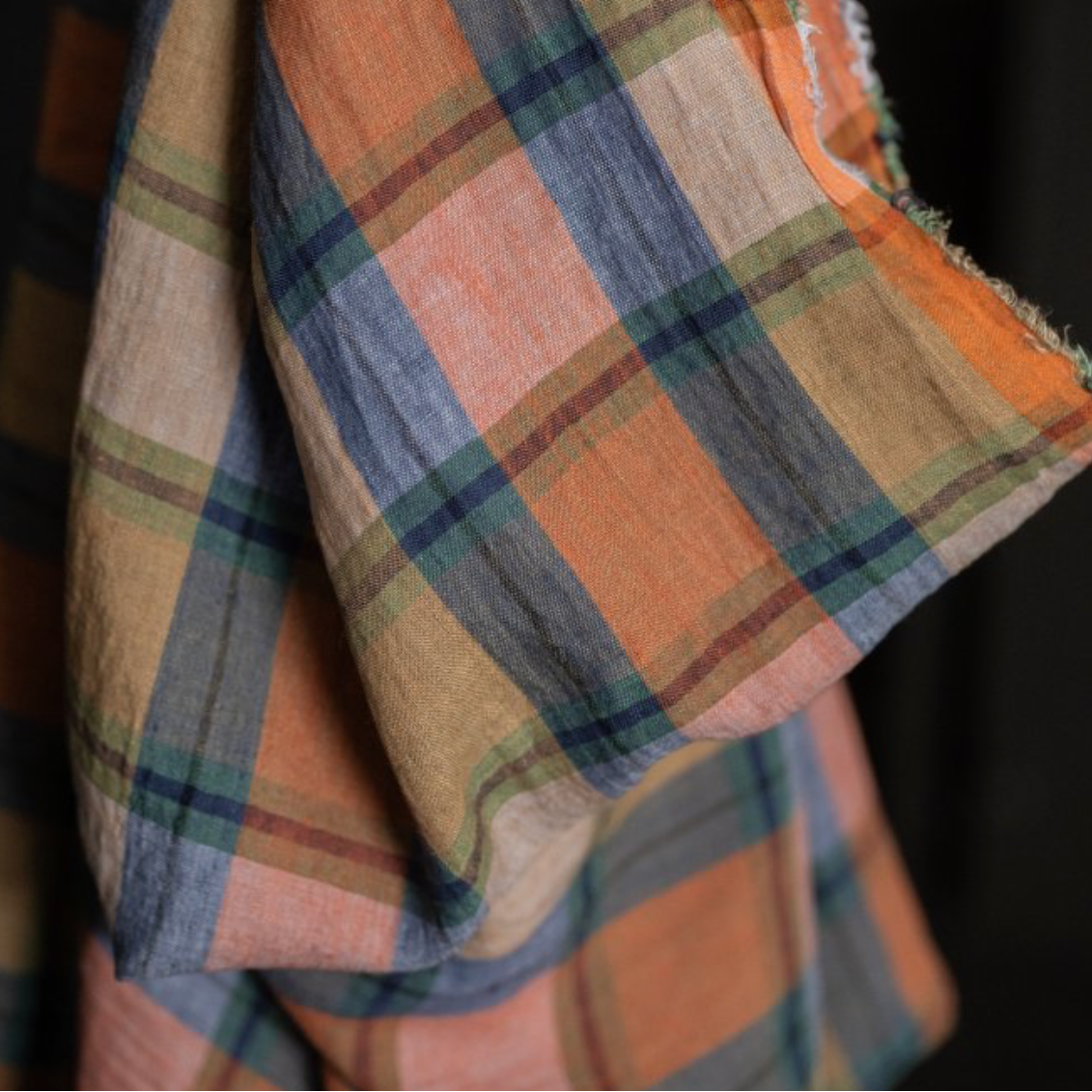 Paid linen fabric, featuring a multicolor pattern of orange, beige, blue, green, and brown.