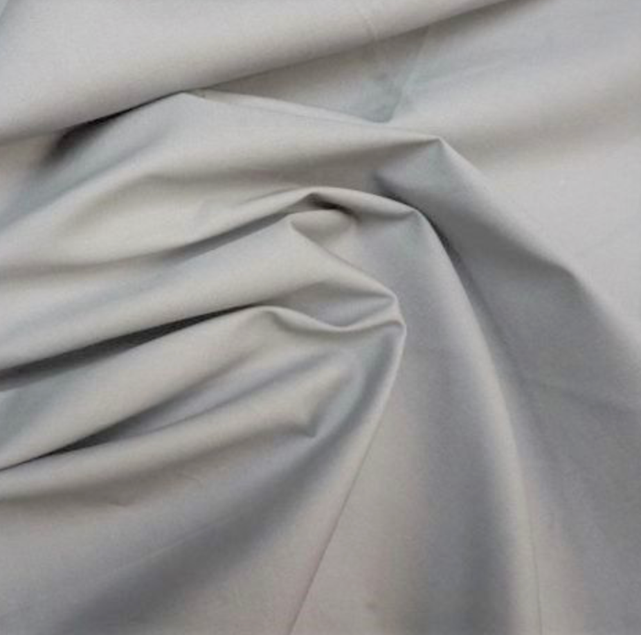 Light gray fabric draped in soft folds, showing a smooth matte texture.